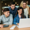 young people looking at a laptop