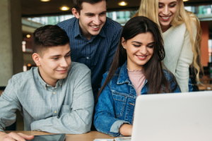 young people looking at a laptop